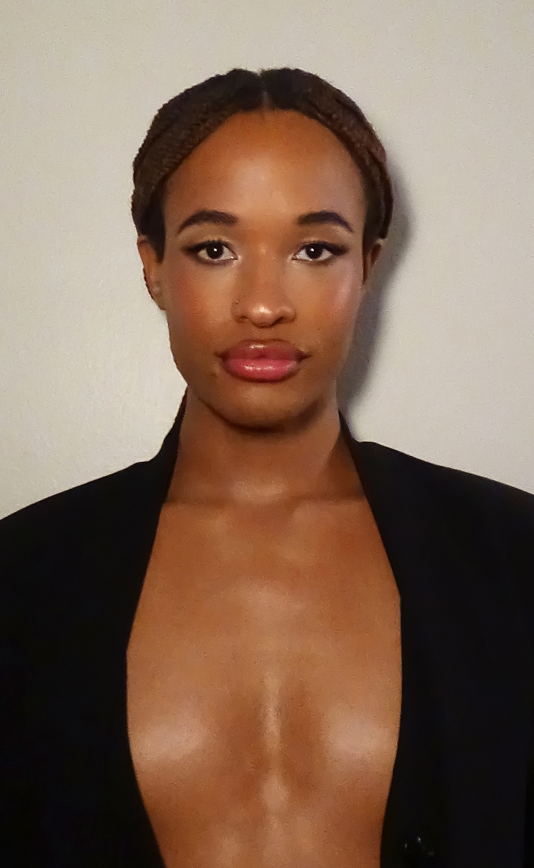 Close up portrait of Jules Crosby with soft glam makeup looking at the camera against a white backdrop